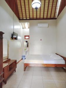 Postel nebo postele na pokoji v ubytování Dapur Ethnic Homestay