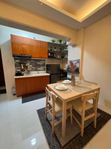 a kitchen with a wooden table and chairs at My Condo City in Lapu Lapu City