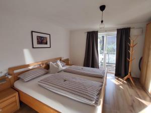a large bed in a room with a window at Apartment Nanni in Kirchanschöring