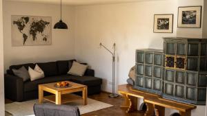 a living room with a black couch and a table at Apartment Nanni in Kirchanschöring