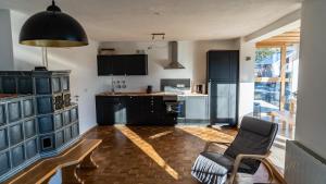 a kitchen with black cabinets and a chair in it at Apartment Nanni in Kirchanschöring