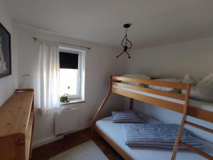 a bedroom with a bunk bed and a window at Apartment Nanni in Kirchanschöring +10 photos