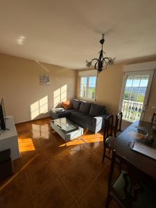 a living room with a couch and a table at Casa Pepe in Ourense