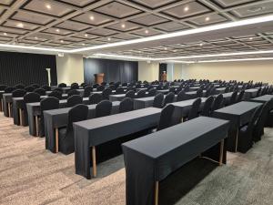 an empty room with chairs and tables in it at WAVEM HOTEL East in Siheung +37 photos