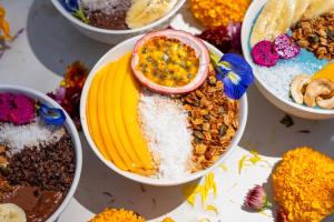 a table topped with bowls of different types of desserts at Orion Healing Centre in Srithanu