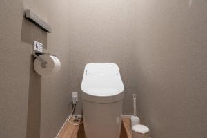 a small bathroom with a white toilet in a room at RERESO Motohakone in Hakone +39 photos