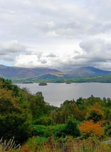 a view of a lake with mountains in the distance at Catbells Sunrise Cottage Borrowdale Lake District in Keswick