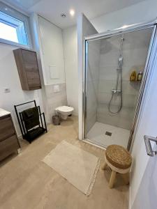a bathroom with a shower and a toilet and a stool at Elegance Centre Sète in Sète