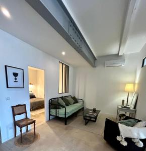 a living room with a couch and a bed at Elegance Centre Sète in Sète
