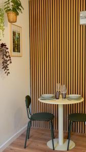 a table and two chairs with plates on it at Tropical Jungle in Béziers
