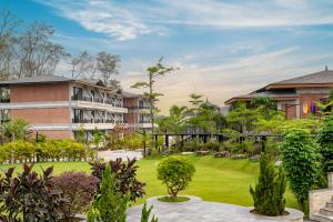 an exterior view of a resort with a garden at Royal Tulip Chitwan Nepal in Sauraha