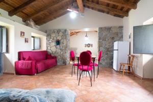 a living room with red chairs and a table at Dimora Storica Dei Nelson in Maniace