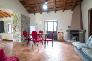 a living room with a table and chairs and a fireplace at Dimora Storica Dei Nelson in Maniace