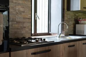 a kitchen with a stove top oven next to a sink at Dimora Storica Dei Nelson in Maniace +76 photos