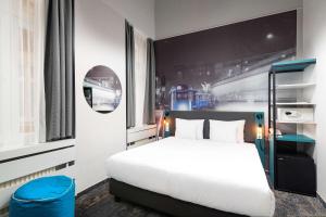 a bedroom with a white bed and a blue stool at Three Corners Hotel Anna in Budapest