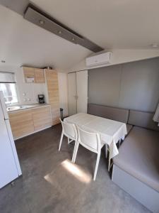 a kitchen with a table and chairs in a room at Camping Agde in Agde