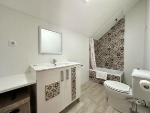 a bathroom with a sink and a toilet and a tub at El Nido de Ris in Noja +73 photos