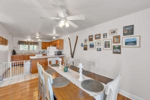 a dining room with a table and a ceiling fan at Uncas 16N - Spacious & Scenic Townhome in North Creek