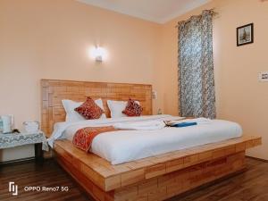 a bedroom with a large bed and a window at Moonshine Homestay Kashmir in Srinagar +164 photos