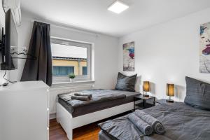 a bedroom with two beds and a window at BE01 Große Wohnung in Dieburg in Dieburg