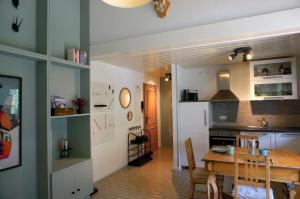 a kitchen and dining room with a wooden table at BERG & WALD Ferienwohnungen in Schönau am Königssee