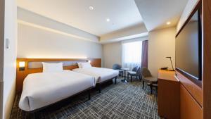 Postel nebo postele na pokoji v ubytování JR-East Hotel Mets Komagome