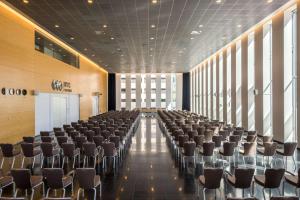 a large room with rows of chairs in it at NH Den Haag in The Hague
