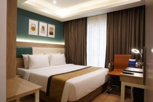 Postel nebo postele na pokoji v ubytování Sarovar Portico Kolkata