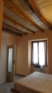 a bedroom with a bed and two windows at Il CORTILETTO in Acquaseria +14 photos