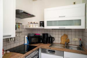 a kitchen with a sink and a microwave at Ferienwohnung Bahnhof Wendehausen in Wendehausen