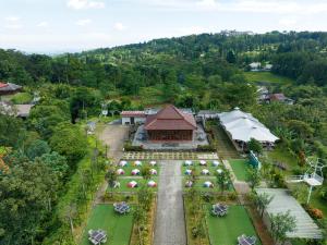 an aerial view of a resort with tables and a building at The Glamping at ARTOTEL Pelangi Park in Pasirkuda