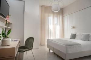 En eller flere senge i et værelse på Hotel Villa Tosi