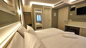 Voodi või voodid majutusasutuse Hotel Guerrini toas