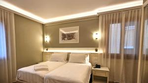 Voodi või voodid majutusasutuse Hotel Guerrini toas
