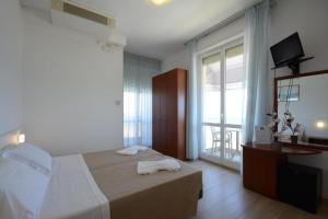Postel nebo postele na pokoji v ubytování Hotel Caravel
