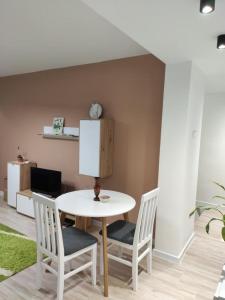 a white table and chairs in a room at KS Studio 2 in Belgrade