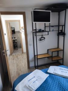 a bedroom with a bed with a tv on it at Casa Bonita pachino Tiny House in Pachino