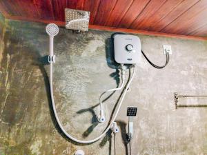 a shower in a dirty room with a shower at Sigiriya Eco Tree House in Sigiriya