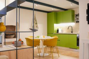 a kitchen with green cabinets and a table and chairs at Casa Sveva in Vieste
