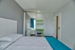 Postel nebo postele na pokoji v ubytování Grisverde Suites Hotel