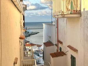 a view of the ocean from between two buildings at Casa Sveva in Vieste