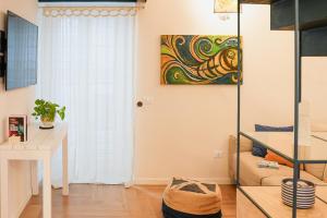 a living room with a desk and a painting on the wall at Casa Sveva in Vieste