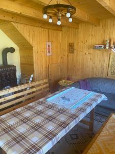 a room with a couch and a table in a room at Ivói Faház in Izvoare
