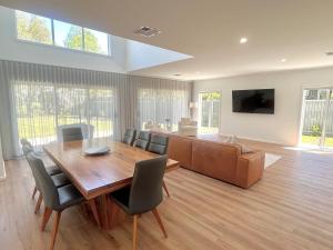 a dining room with a wooden table and chairs at Yarrawonga Golf & Lake Getaway in Yarrawonga