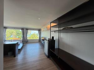 a large living room with a large window at P168 Hostel Samui in Chaweng