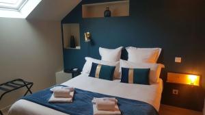 Menetou-RâtelにあるMaison Fleuriet - Grand gîteのタオルが敷かれた大きなベッドのある寝室