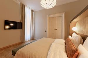 Postel nebo postele na pokoji v ubytování Hotel Palais Mailberger Hof