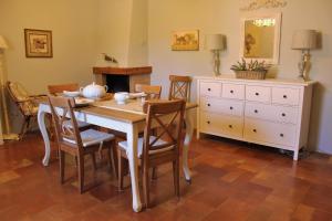 a dining room with a table and chairs and a dresser at Casa Verde Conero in Castelfidardo