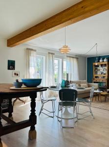 a living room with a table and chairs at Ferienhaus Landleven in Hessenburg +16 photos