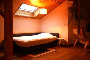 a bedroom with a bed in a room with a window at Eco-gîte Belle-étoile in Verrens-Arvey